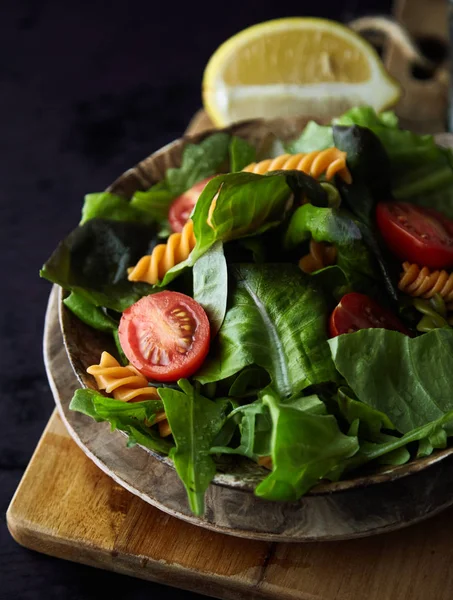 Salad pasta Fusilli dengan tomat berwarna-warni dan daun kemangi di d — Stok Foto