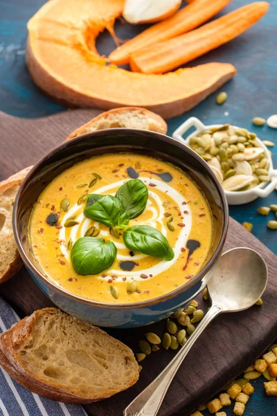 Délicieuse soupe de citrouille maison aux feuilles de basilic . — Photo