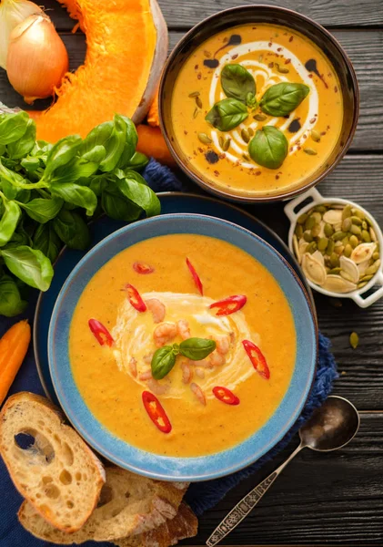 Delicious homemade pumpkin soup with prawns, chili and basil lea — Stock Image Delicious homemade pumpkin soup with prawns, chili and basil lea Stock Image