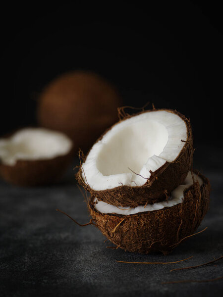 Coconut halves on a dark background