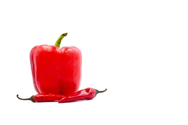 Red bell bulgarian pepper and two hot peppers on a white background Stock Picture