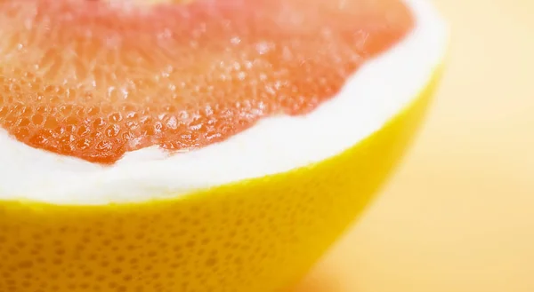 Half red pomelo with a yellow peel closeup — 스톡 사진