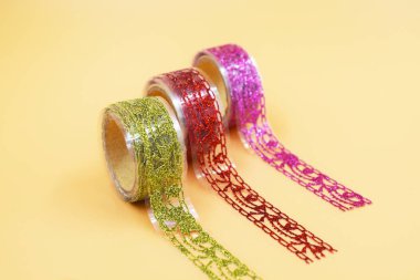 Decorative shiny multi-colored ribbons. New Year's serpentine. three rolls. parallel lines