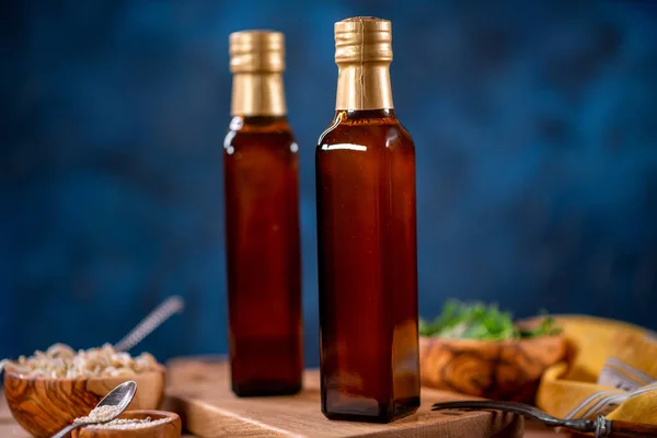 Two Bottles Olive Oil Bowl Olives Salad Wooden Board Side — Stock Photo, Image