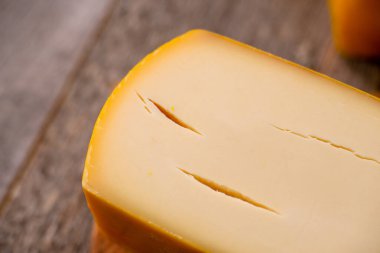 Tahtada parmesan parmesan peyniri ve çatal ahşap desenli gün ışığı manzaralı.