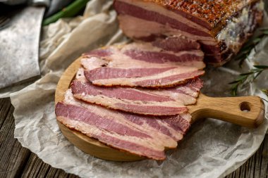 Kağıt üzerinde tuzlanmış domuz pastırması, mutfak baltası, mutfak mutfağı ahşap dokular.