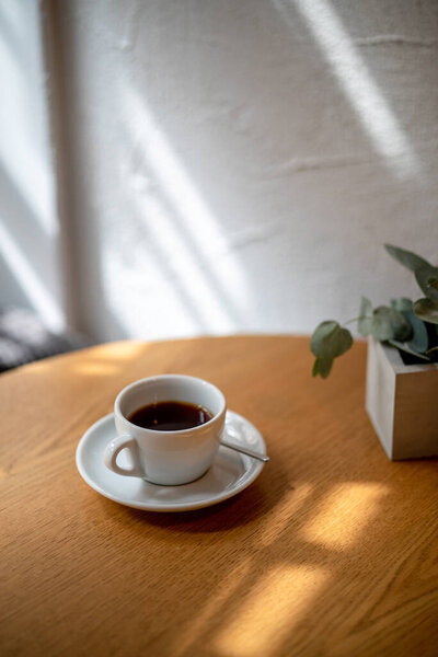 cup of black filter coffee on the table in coffee house cafe coffeebreak sunlight daylight side view