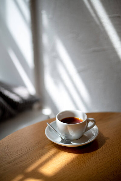 cup of black filter coffee on the table in coffee house cafe coffeebreak sunlight daylight side view
