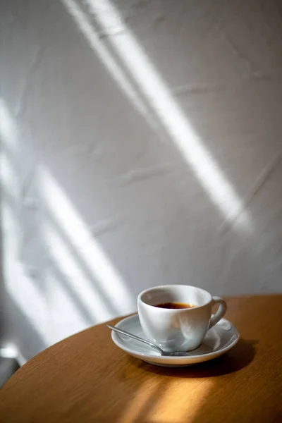 cup of black filter coffee on the table in coffee house cafe coffeebreak sunlight daylight side view