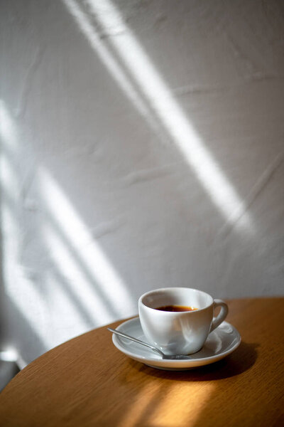 cup of black filter coffee on the table in coffee house cafe coffeebreak sunlight daylight side view