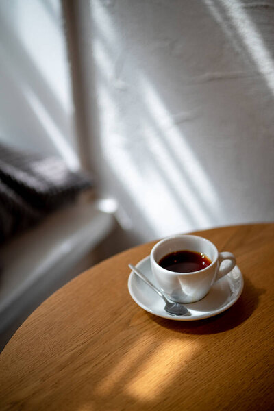 cup of black filter coffee on the table in coffee house cafe coffeebreak sunlight daylight side view