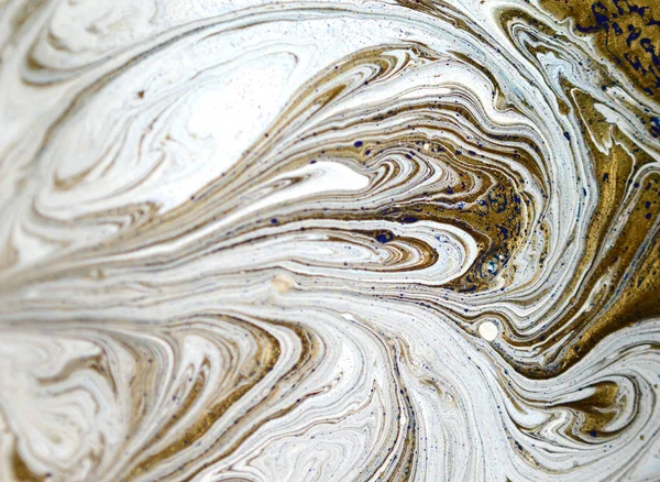 Liquid gold marbled pattern. Pale beige background