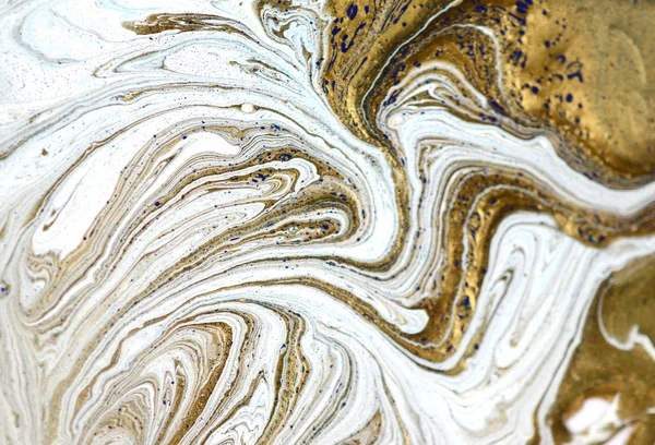 Liquid gold marbled pattern. Pale beige background