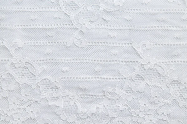 White lace with small flowers on the white background. Royalty Free Stock Images