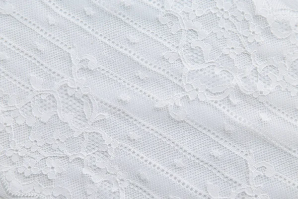 White lace with small flowers on the white background. Stock Picture