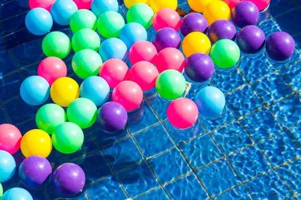 Colorful plastic balls in pool , pool villa house.