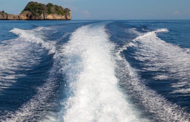 Bir yüksek hızlı tekne ve Adası arka plan, seçici odak dalgalardan.