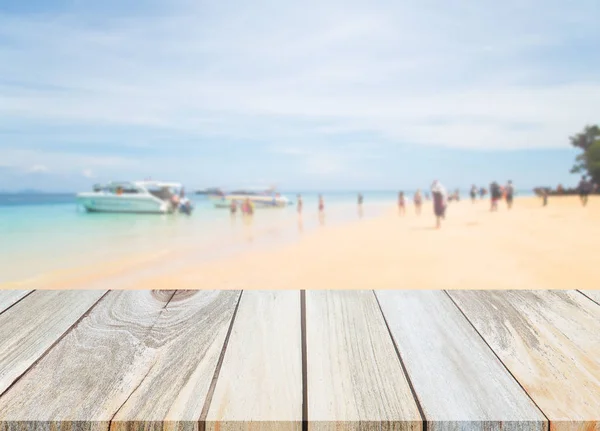 Holz Tischplatte und verschwimmen Hintergrund des Strandes. — Stockfoto