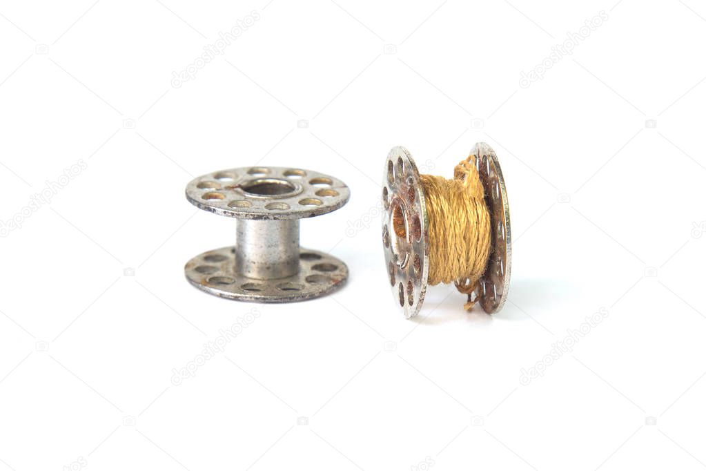 Metal spool of thread isolated on white background.