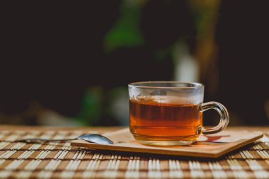 Cam bardak çay, çay kaşığı ahşap tablo.