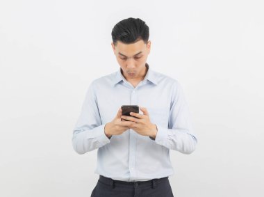Beyaz arka planda izole edilmiş şaşırtıcı yüzüyle akıllı telefon çalan Asyalı genç iş adamı..