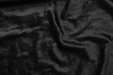 Soyut siyah kumaş kumaş dokusu arka plan veya sıvı dalga veya dalgalı kıvrımlar.