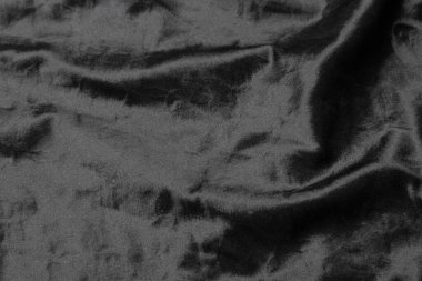 Soyut siyah kumaş kumaş dokusu arka plan veya sıvı dalga veya dalgalı kıvrımlar.