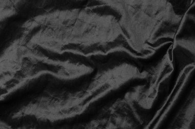 Soyut siyah kumaş kumaş dokusu arka plan veya sıvı dalga veya dalgalı kıvrımlar.