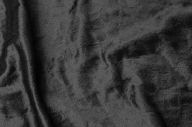 Soyut siyah kumaş kumaş dokusu arka plan veya sıvı dalga veya dalgalı kıvrımlar.