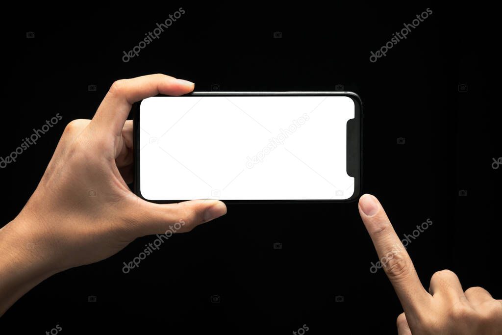 Male hands holding and using smartphone with blank screen at night, Overwork and late work concept, Clipping path.