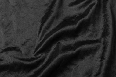 Soyut siyah kumaş kumaş dokusu arka plan veya sıvı dalga veya dalgalı kıvrımlar.