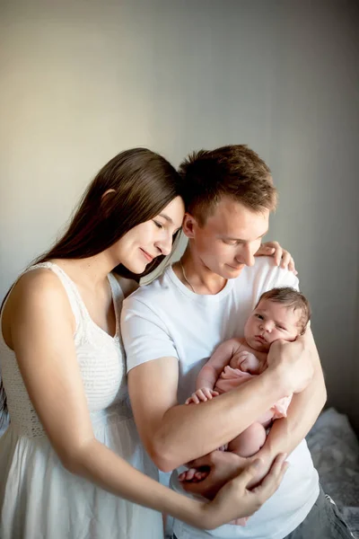 Newborn baby with mom and dad at home