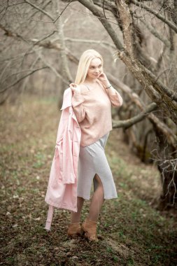 Güzel hamile kadın nisan ayında bahar ormanlarında yürür.