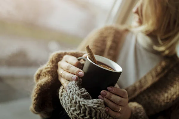 Women holding dark mug with red hot drink during festive period- Christmas time. (Shallow depth of field)