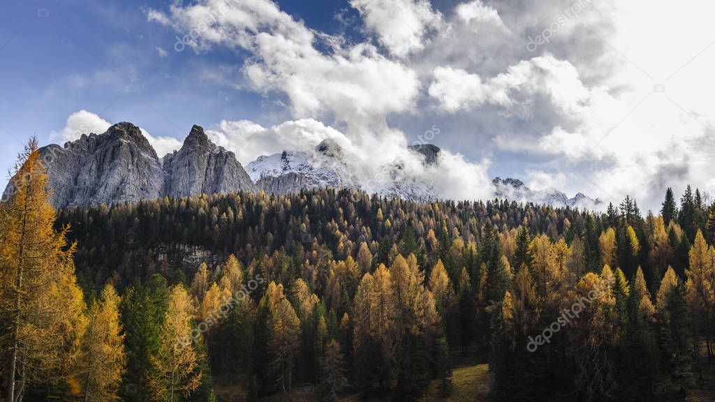 Dolomite mountains surrounded by clouds in South Tyrol, Italy 