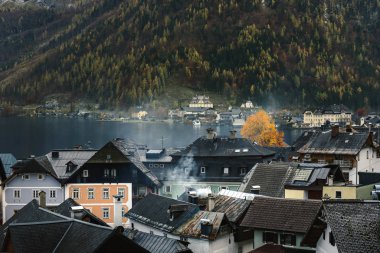 Hallstatt village buildings built on a steep mountain next to   Hallstatter lake in Austria, Alp region  clipart