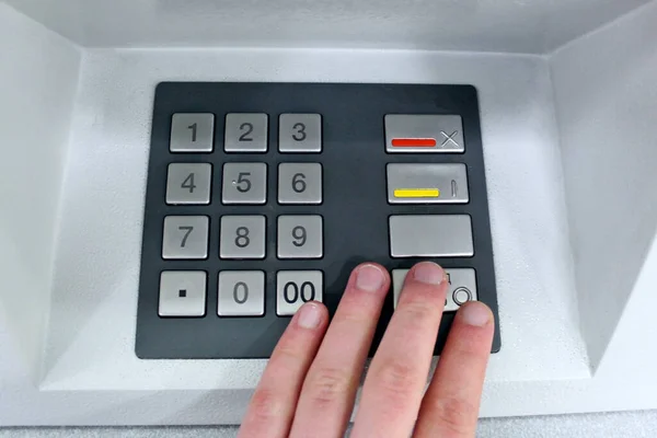 Close-up of hand entering pin code at ATM machine. Finance, money, bank and Technology Automatic machine background concept