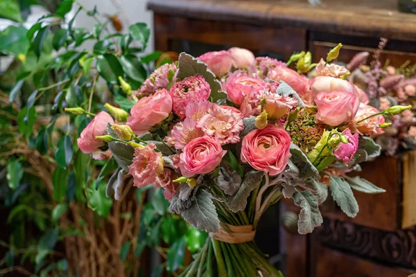 Beautiful multi-colored bouquet of mixed roses and other flowers in a shop. Fresh cut flowers