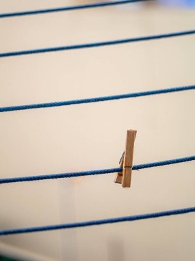 Çamaşır ipindeki ahşap mandal yağmurdan sonra damlalar sallanıyor..