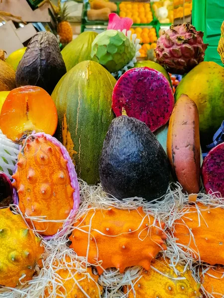 Egzotik meyveli bir vitrin. Yarıkta ejderha meyvesi var. Parlak renkler. Vitaminler. Sağlıklı beslenme. mobil fotoğraf.