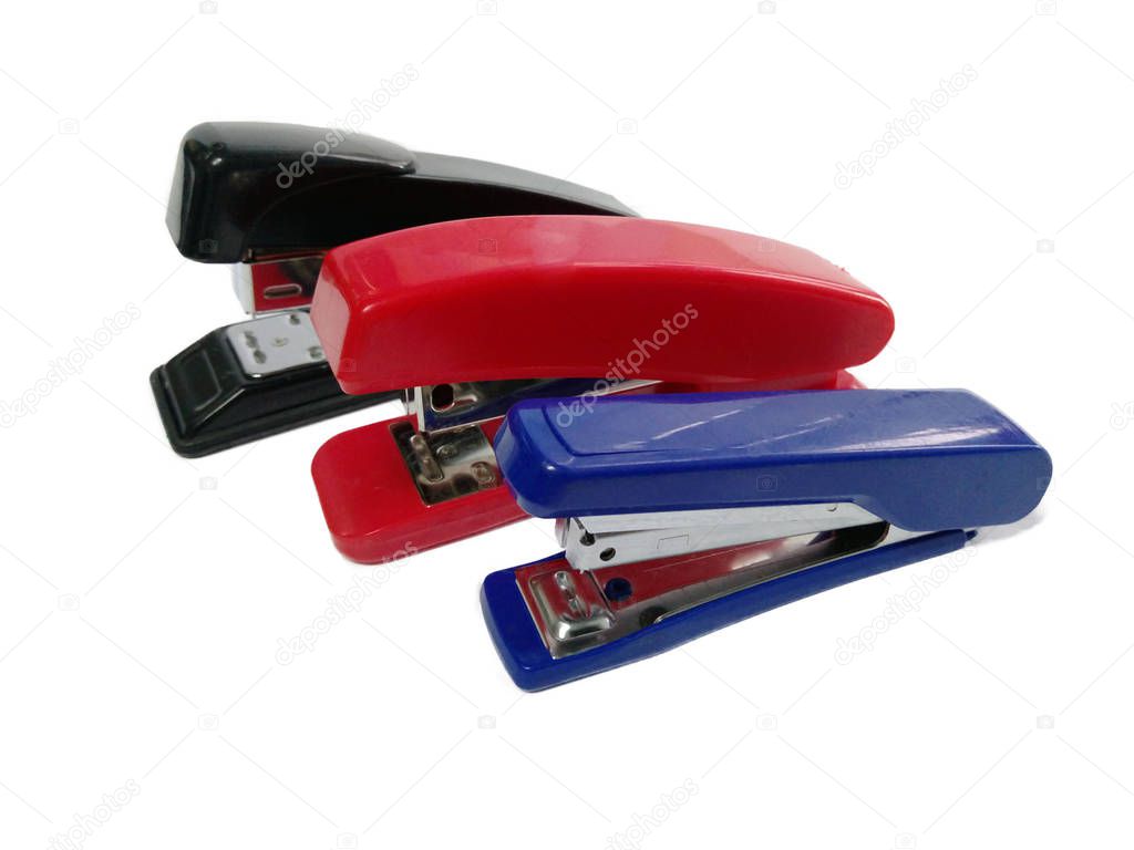 Three colored blue red and black staplers on a white background. isolate. office supplies.