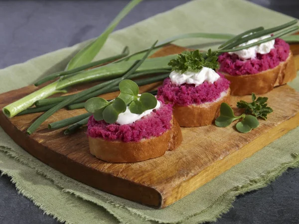 Ethnic food, rustic sandwiches. Beetroot hummus with parsley and green onions Vegetarian food, sandwiches. Healthy eating