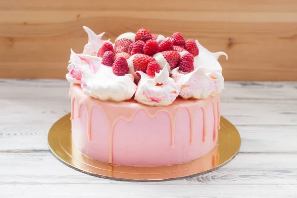 Kremalı pembe pasta, erimiş çikolata ve taze ahududu..