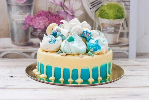 Blue cake with white melted chococlte, meringue clouds, fondant crown and marshmallows.
