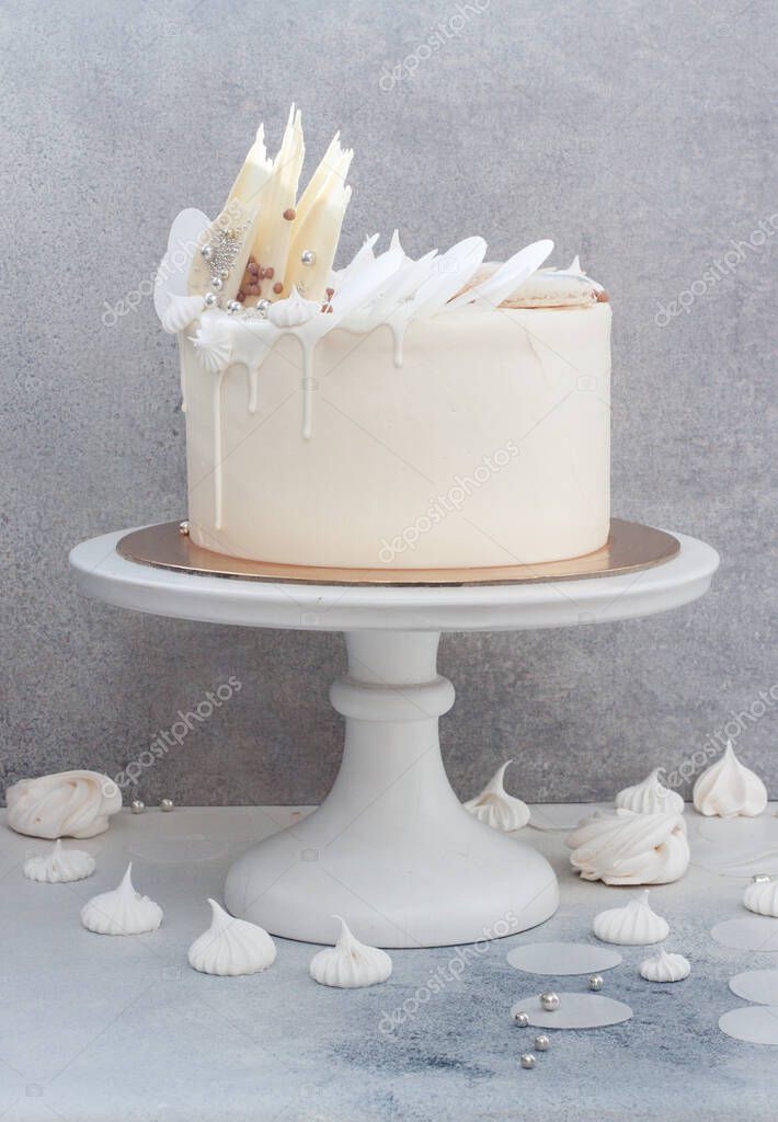 Elegant White Wedding Cake With Chocolate Decoration Meringues And Macaroons On Grey Background Larastock