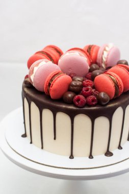 Erimiş çikolatalı kek, kırmızı ve pembe Fransız kurabiyeleri, taze ahududu ve çikolatalı mantarlı beyaz kek. Düz arkaplan