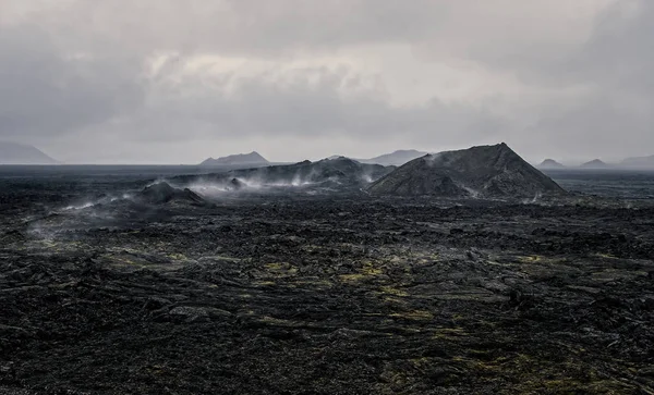 Leirhnjukur old black lava field and smoke in Iceland, overcast. Cloudy day in September 2019 — 스톡 사진