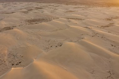 Sand on dunes Corralejo Playas on Fuerteventura. Aerial drone view in october 2019