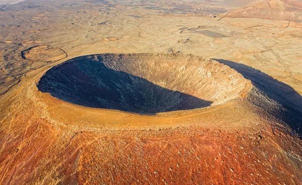 Beautiful panoramic birds eye view on Calderon Hondo, Fuerteventura island. Aerial shooting vulcano around mountains with ocean coastline at sunny day. Travell, Mountains,islands, nature, concept.