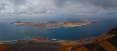 Panoramic aerial view on island of La Graciosa with blue sky and splendid sea. October 2019